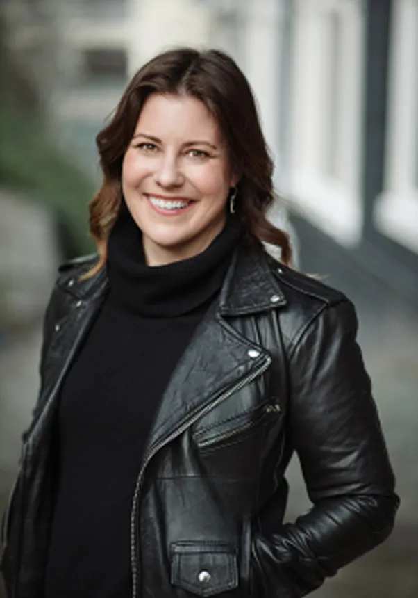 Smiling woman wearing a black leather jacket outdoors