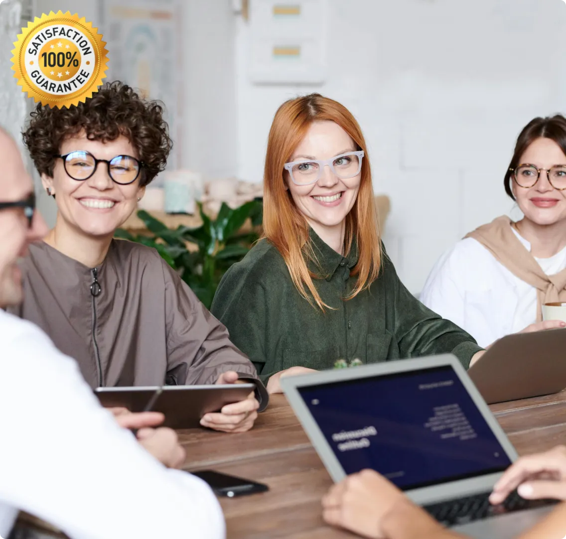 Group of colleagues smiling while working together at a table