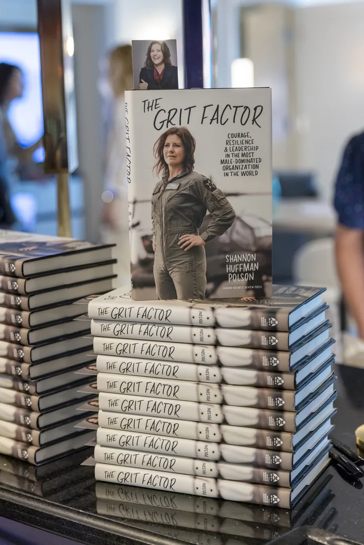Stacks of The Grit Factor at a book signing
